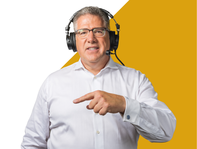 Tommy Grisafi pointing and wearing a headset